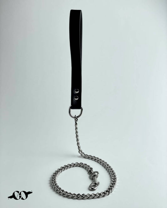A black leather BDSM leash with a strong metal chain attached, designed for bondage play.
