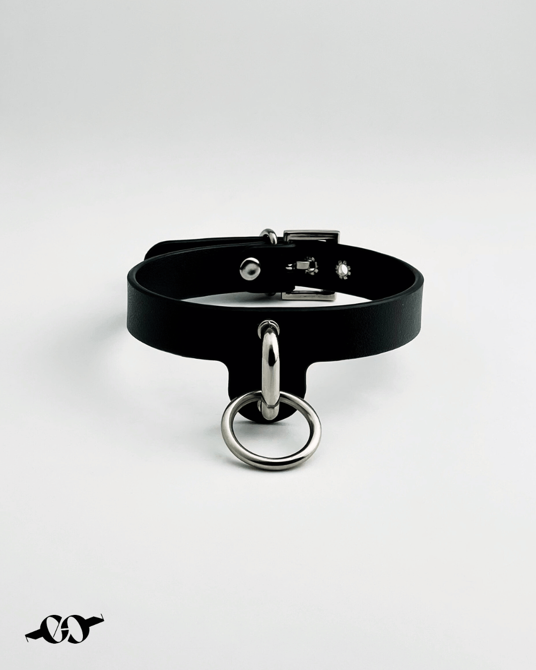 A black leather O ring collar with a metal O ring attachment, displayed against a white background.