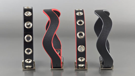 Row of black and red leather day collars with silver O-rings and buckle hardware