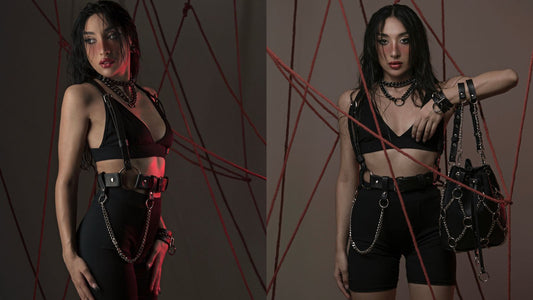 Model styling a black leather chain belt and chain harness over shorts and a crop top